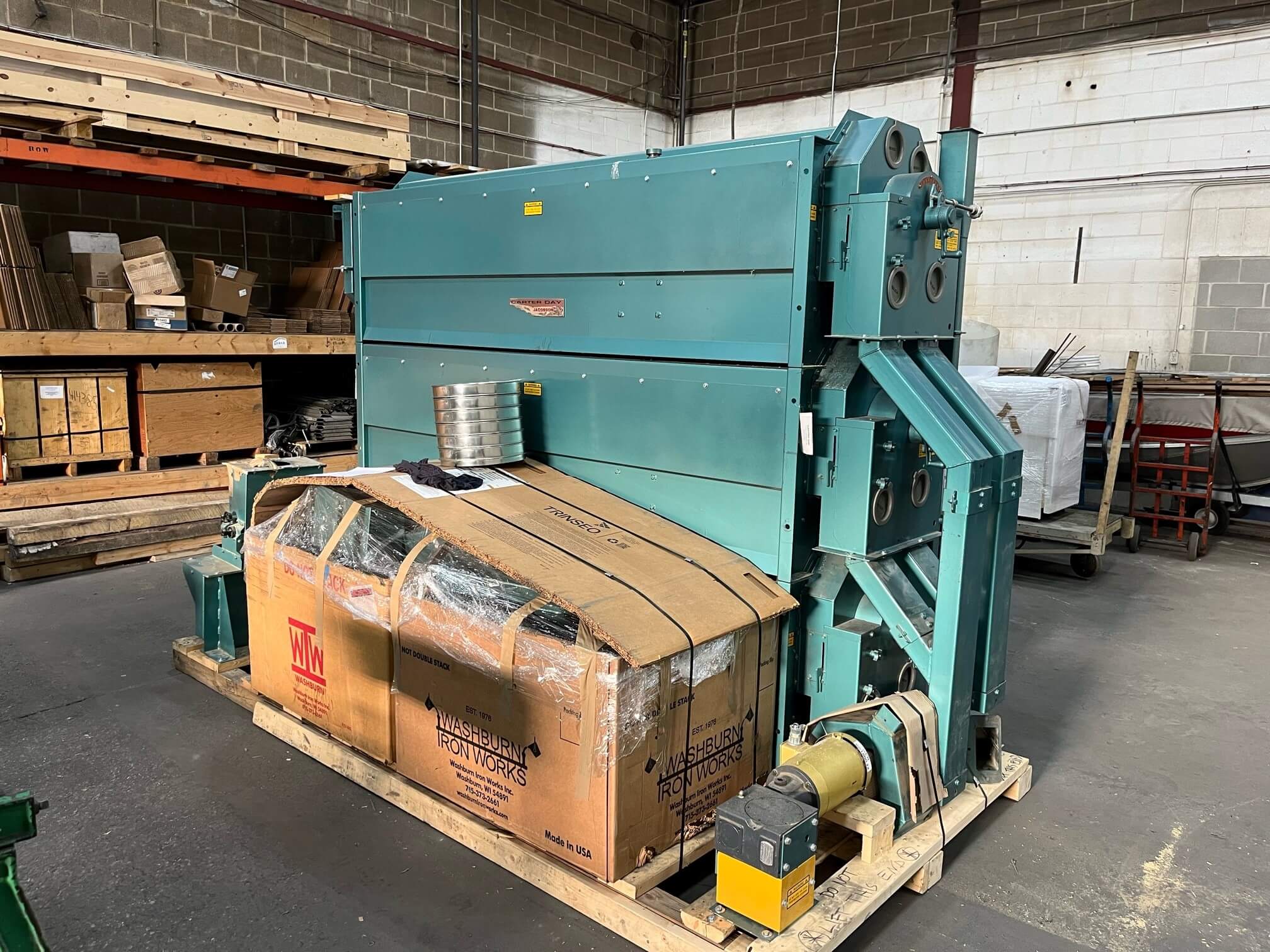 Carter Day Uniflow indent separator stacked three high on a pallet in a warehouse