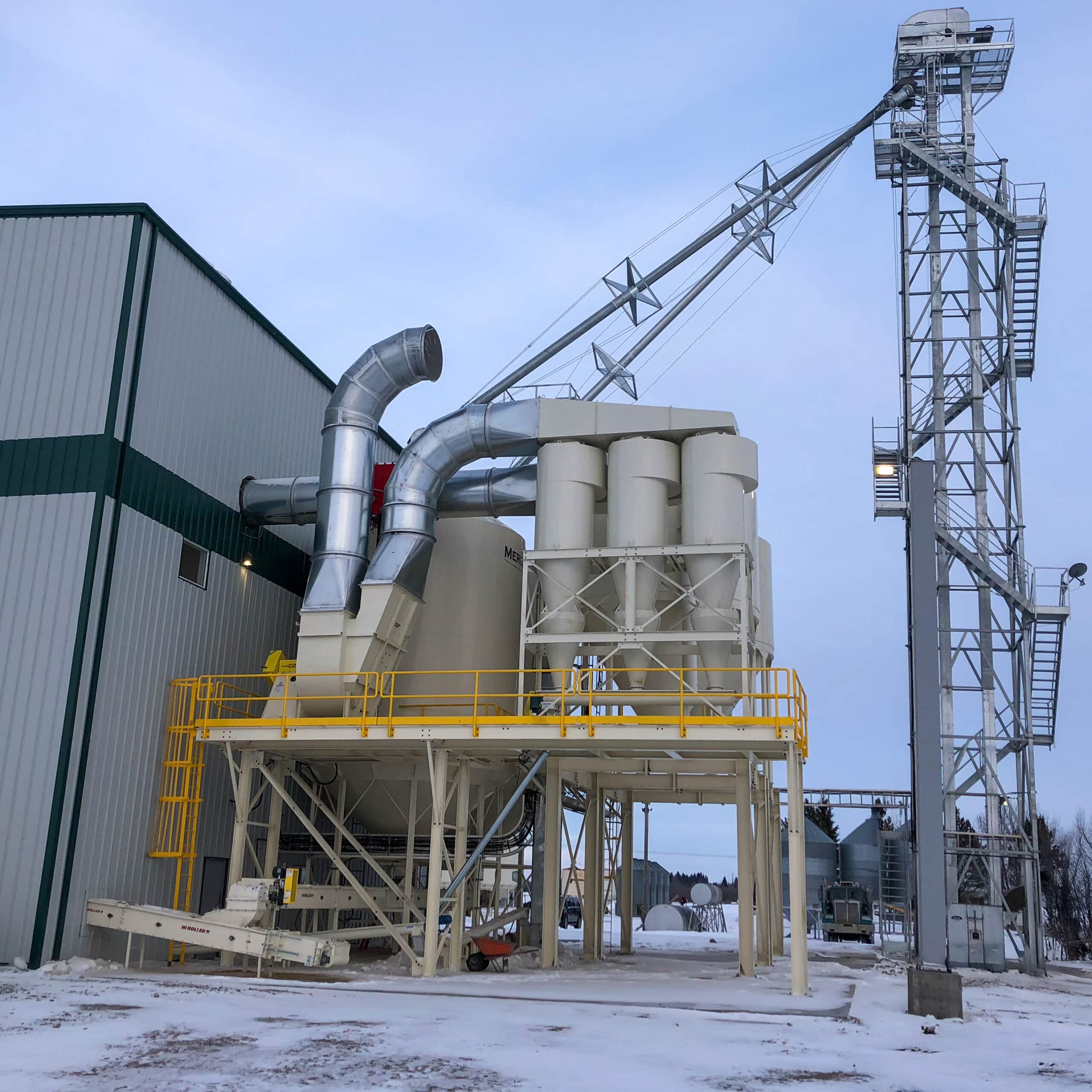 Grain bucket elevator for seed processing facility