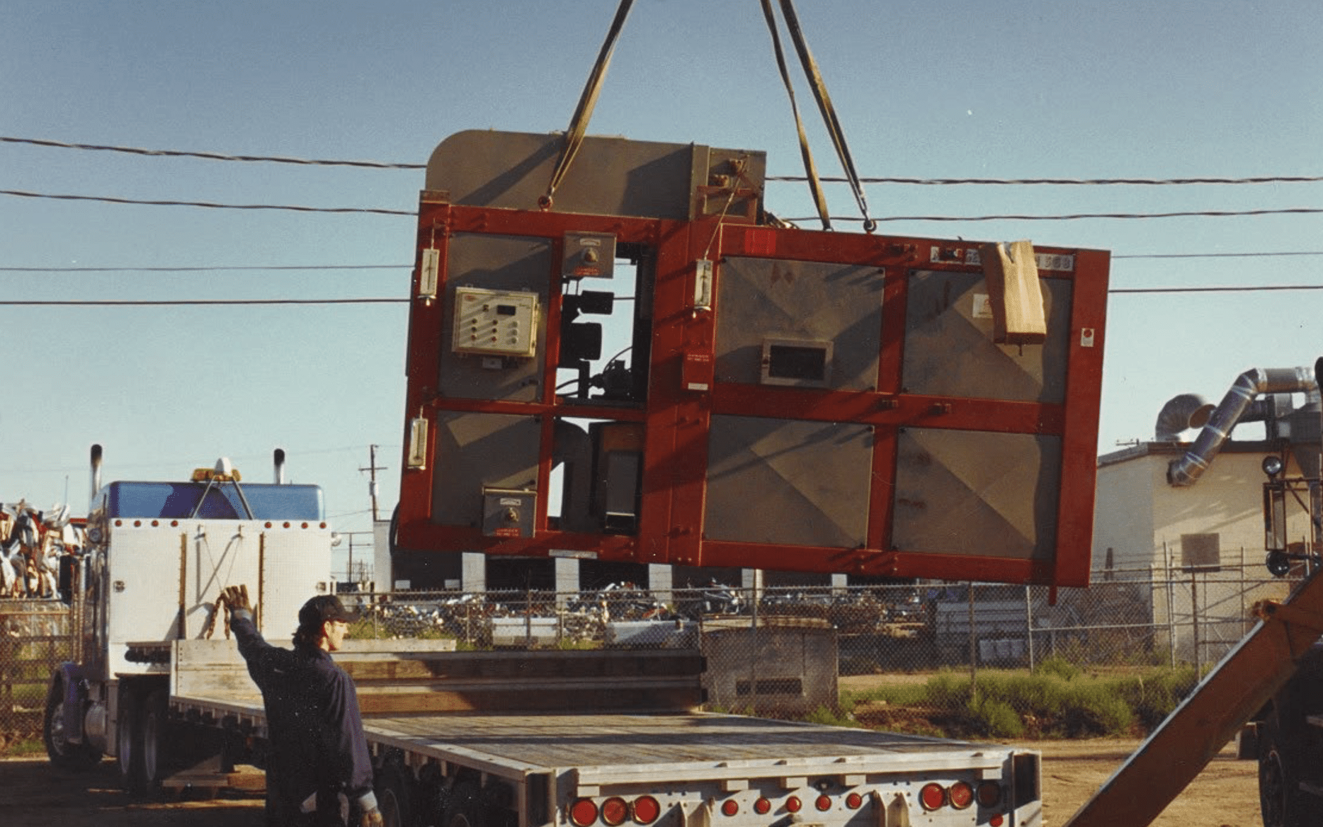 Vistasort — Crane loading a Clipper air screen cleaner outside the Vistasort shop in Saskatoon, 1992
