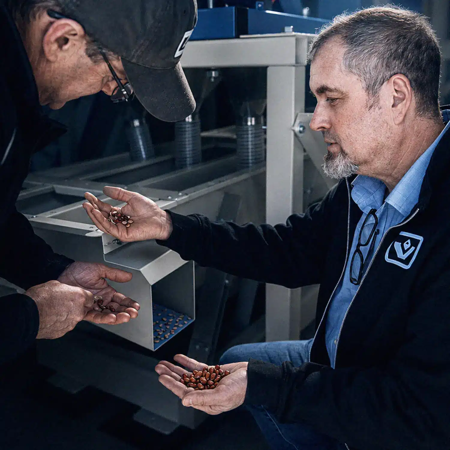 Two Vistasort team members reviewing VistaSort color sorter results on beans
